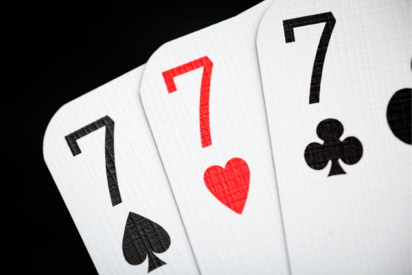 Seven of hearts, spades, and clubs, 777 on playing cards